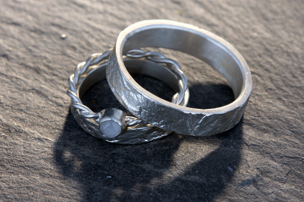 Markante Trauringe mit Kordelring | Regenbogen Mondstein Cabochon | Retikulierte Oberfläche | Handgefertigte Eheringe | Zargenfassung | Goldschmiede Deutschland | Einzigartige Trauringe | Besondere Trauringe | Moderne Trauringe | Außergewöhnliche Eheringe