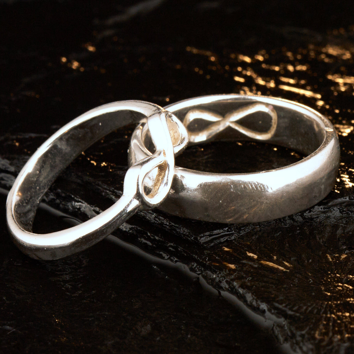  Handgefertigter Statement-Partnerring aus poliertem 925 Silber von Silberschweif mit großer Unendlichkeitsschleife (6x14mm). Die Schiene verjüngt sich elegant zum Motiv. Massiver 6mm Herrenring aus Silber. In der Innenansicht zeigt sich das fest eingravierte Unendlichkeits-Symbol als geheimes Zeichen der Verbundenheit.  Das Partnerring-Set „Ewigkeit“ zeigt das plastische Design des Damenrings und die spiegelnde Oberfläche des massiven Herrenrings